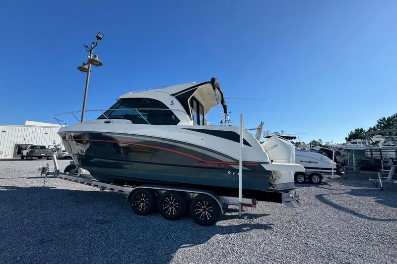 Slide: The Image of 2020 Beneteau Antares 27 boat on trailer under clear blue sky. - 10
