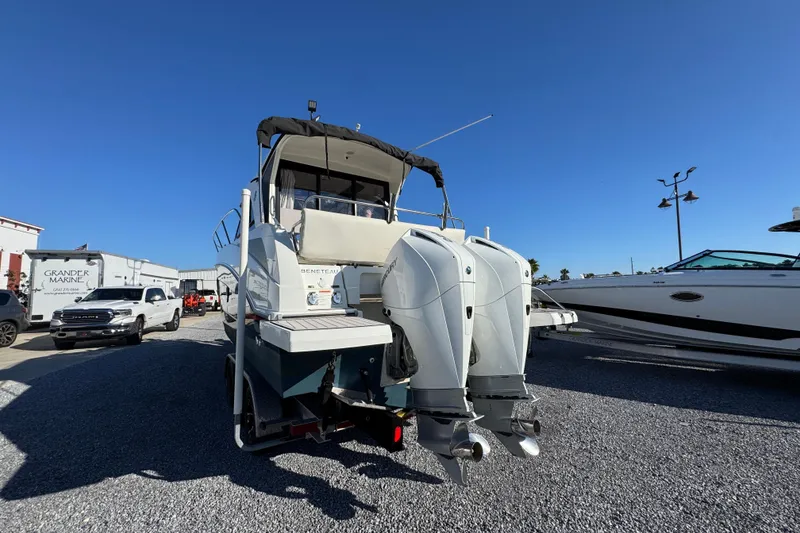Slide: The Image of 2020 Beneteau Antares 27 boat with dual outboard motors in a marina setting. - 13