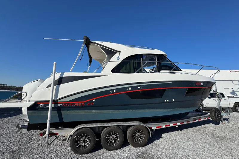 Slide: The Image of 2020 Beneteau Antares 27 boat on trailer under clear blue sky. - 17