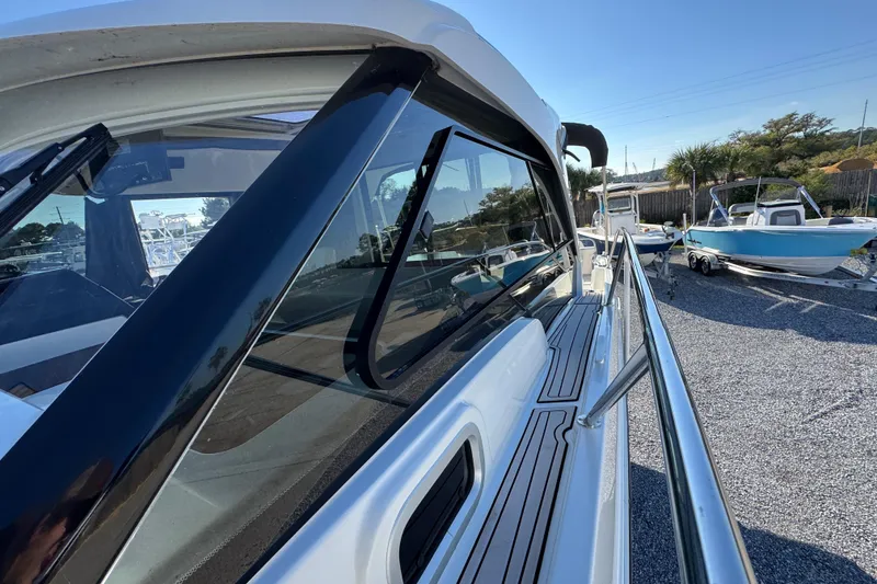 Slide: The Image of 2020 Beneteau Antares 27 boat side view with sleek design and railing. - 22