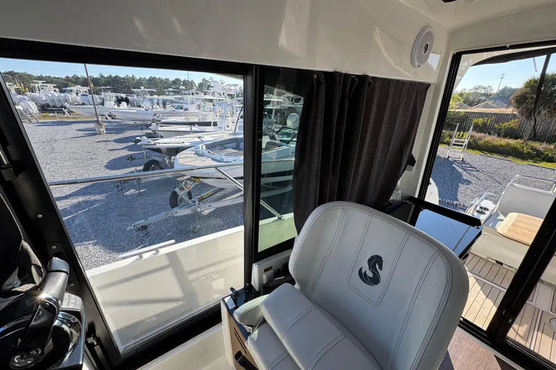 Slide: The Image of Interior view of 2020 Beneteau Antares 27 boat with marina background. - 30