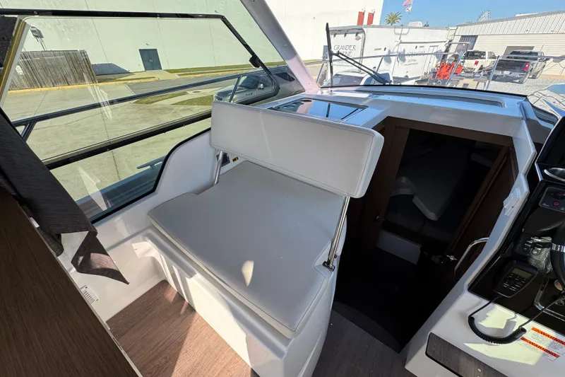 Slide: The Image of Interior view of 2020 Beneteau Antares 27 boat, featuring seating and cabin entrance. - 32