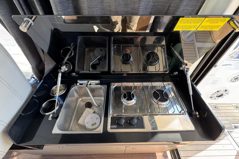 Slide: The Image of 2020 Beneteau Antares 27 kitchen with stove and sink, compact and modern design. - 37