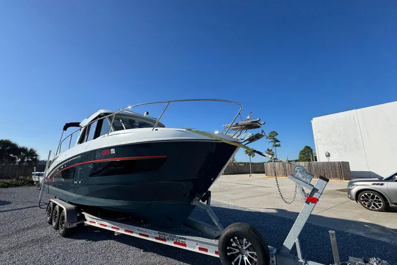 Slide: The Image of 2020 Beneteau Antares 27 boat on trailer under clear blue sky. - 4