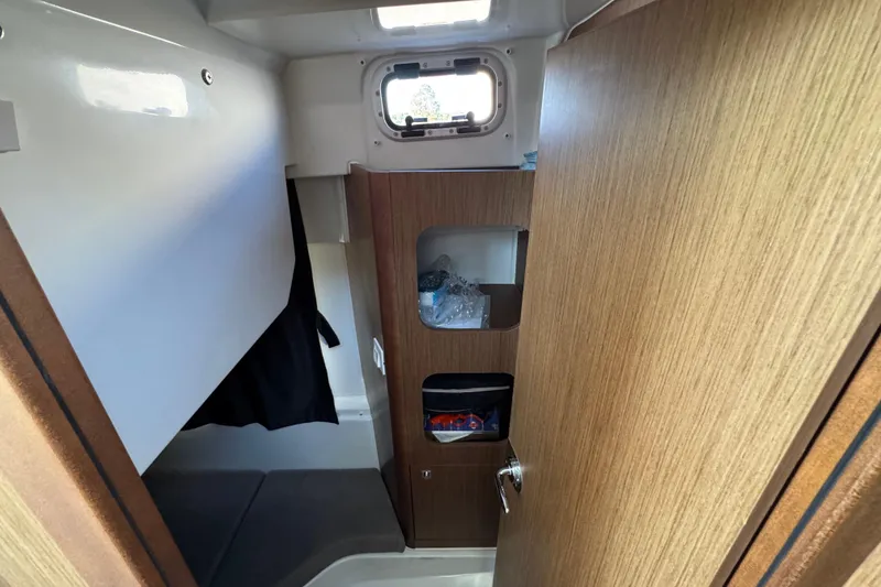 Slide: The Image of Interior cabin of 2020 Beneteau Antares 27 with wood paneling and storage. - 40