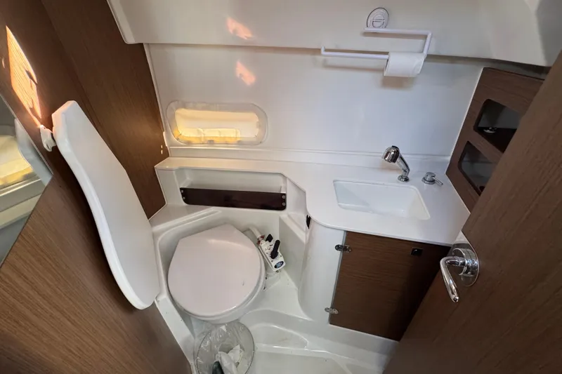 Slide: The Image of Beneteau Antares 27 bathroom interior, featuring a compact toilet and sink, 2020 model. - 42