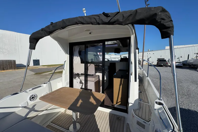 Slide: The Image of 2020 Beneteau Antares 27 boat with outdoor seating and canopy, docked at marina. - 43