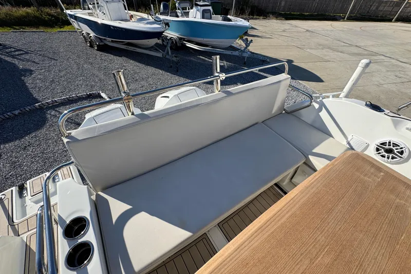 Slide: The Image of Beneteau Antares 27 (2020) boat interior with seating and table, docked outdoors. - 46