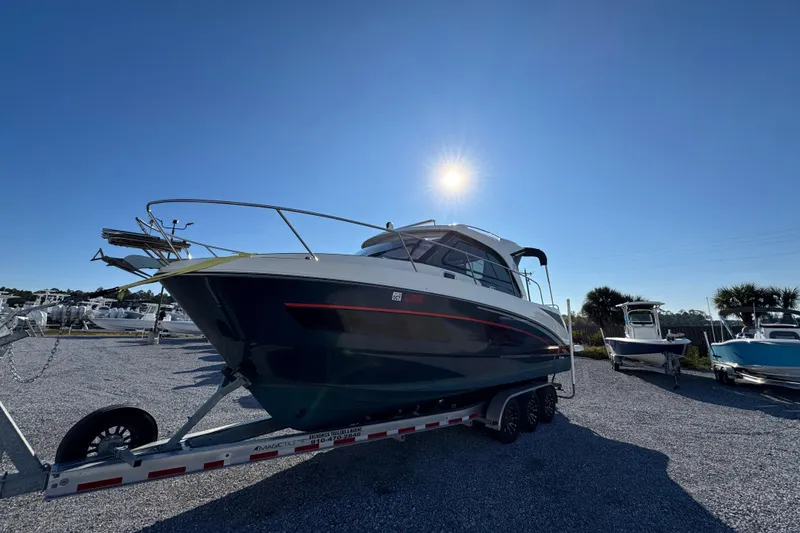 Slide: The Image of 2020 Beneteau Antares 27 boat on trailer under clear blue sky. - 6