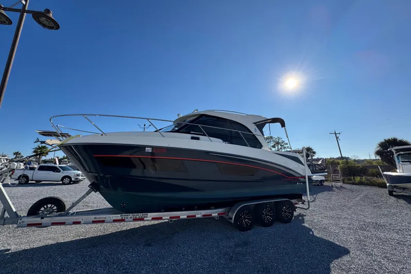 Slide: The Image of 2020 Beneteau Antares 27 boat on trailer under clear blue sky. - 8
