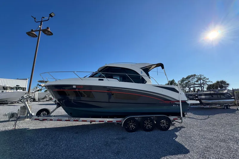 Slide: The Image of 2020 Beneteau Antares 27 boat on trailer under clear blue sky. - 9