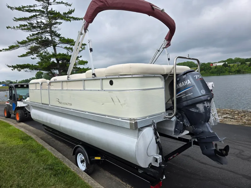 Slide: The Image of 2007 Bennington 2075GL pontoon boat with Yamaha 75 engine on trailer by lake. - 1