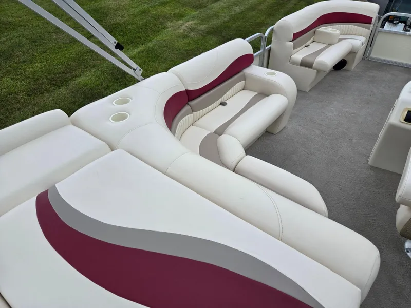 Slide: The Image of 2007 Bennington 2075GL boat interior with white and maroon seating, cup holders, and carpeted floor. - 17