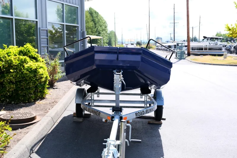 Slide: The Image of Blue Fish Whistle FW109 boat on trailer, parked outdoors, 2023 model. - 3