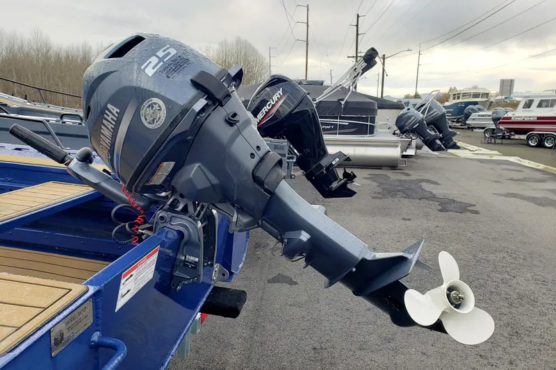 Slide: The Image of Outboard motors on display, featuring Fish Whistle FW109, 2023 model, in a boat dealership. - 5