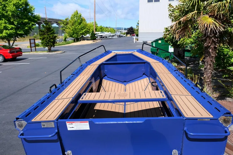 Slide: The Image of Blue Fish Whistle FW109 boat, 2023 model, parked outdoors with wooden deck. - 7
