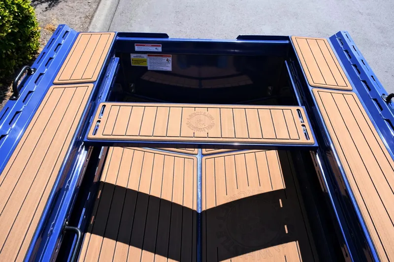 Slide: The Image of 2023 Fish Whistle FW109 boat deck with blue trim and wood finish. - 8