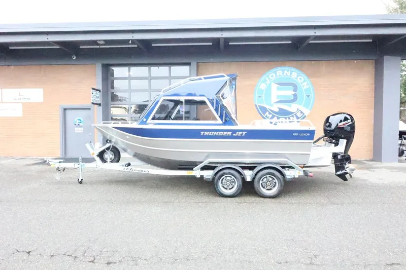 The Image of 2026 Thunder Jet 185 Luxor boat on trailer outside marine dealership. - 1