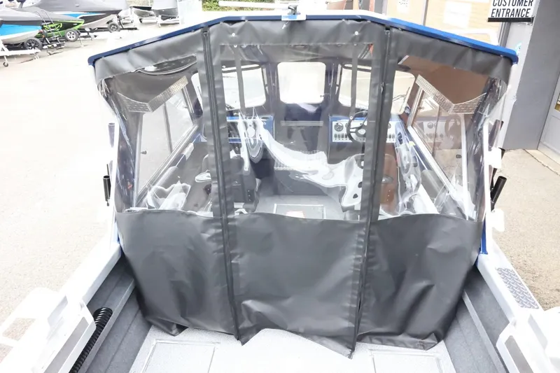 Slide: The Image of 2026 Thunder Jet 185 Luxor boat with covered cockpit, parked outdoors. - 12