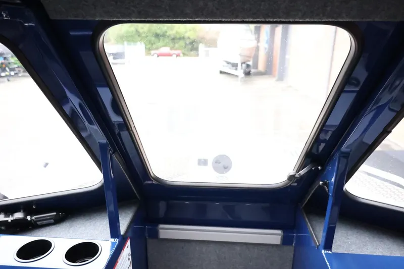 Slide: The Image of Interior view of 2026 Thunder Jet 185 Luxor boat cabin with window and cup holders. - 17