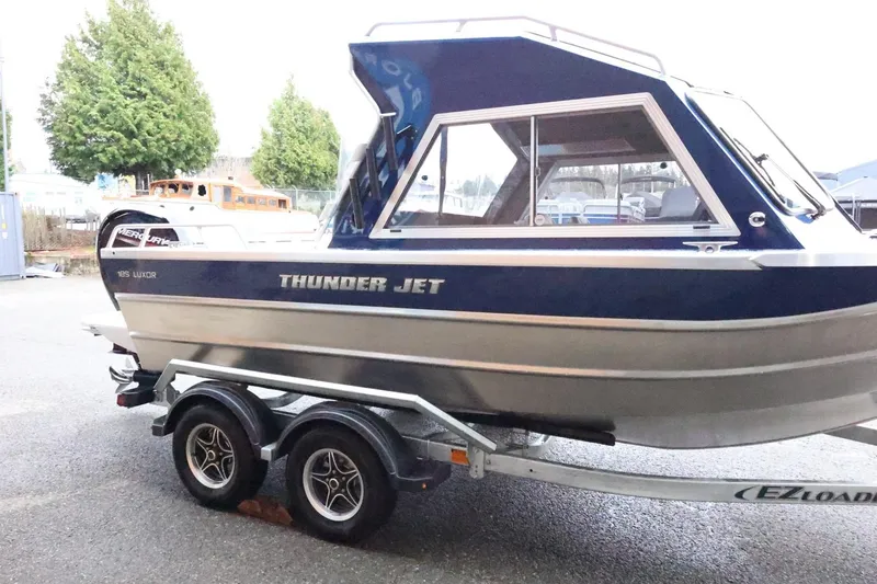 Slide: The Image of 2026 Thunder Jet 185 Luxor boat on trailer, parked outdoors. - 5