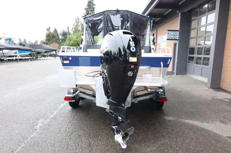 Slide: The Image of 2026 Thunder Jet 185 Luxor boat with 150 HP outboard motor, parked outside a showroom. - 7