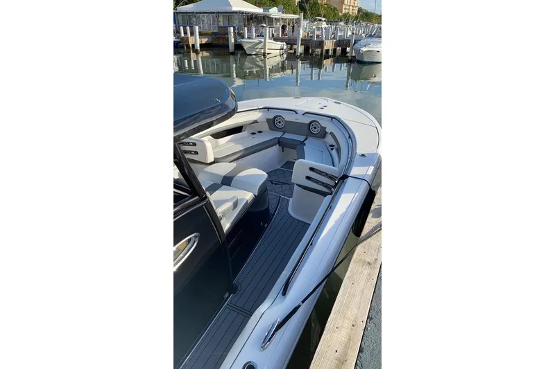 Slide: The Image of 2020 Tidewater 320 CC Adventure boat docked at marina, showcasing sleek interior design. - 5
