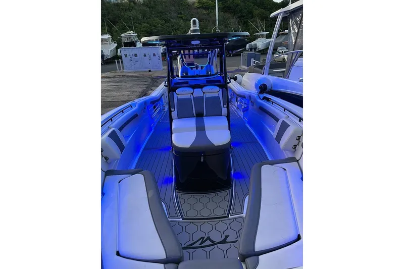 Slide: The Image of 2020 Tidewater 320 CC Adventure boat interior with blue LED lighting. - 7