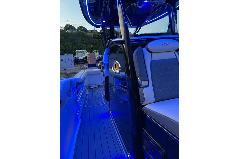 Slide: The Image of 2020 Tidewater 320 CC Adventure boat interior with blue LED lighting. - 8