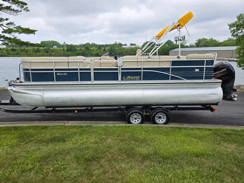 Slide: The Image of 2014 Lowe SS230 Super Sport pontoon boat on trailer by a lake. - 10