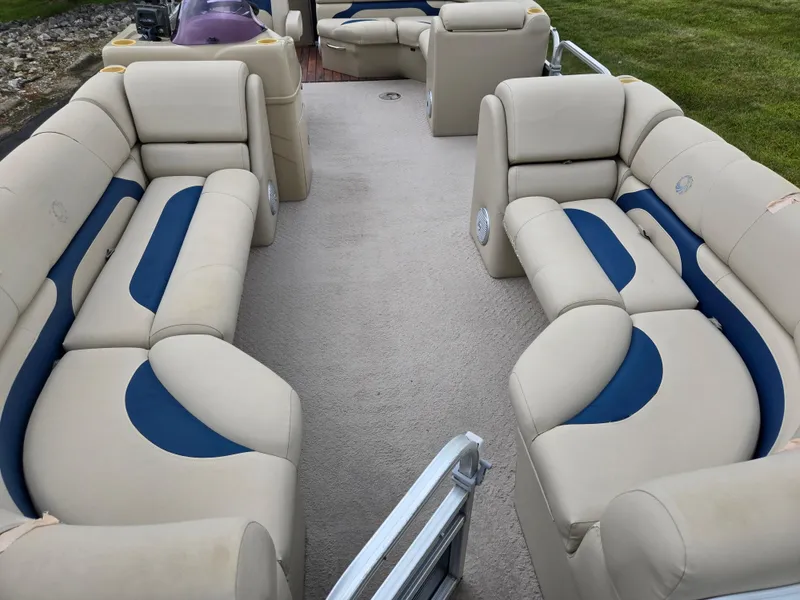 Slide: The Image of 2014 Lowe SS230 Super Sport pontoon boat with beige and blue seating, spacious interior. - 11