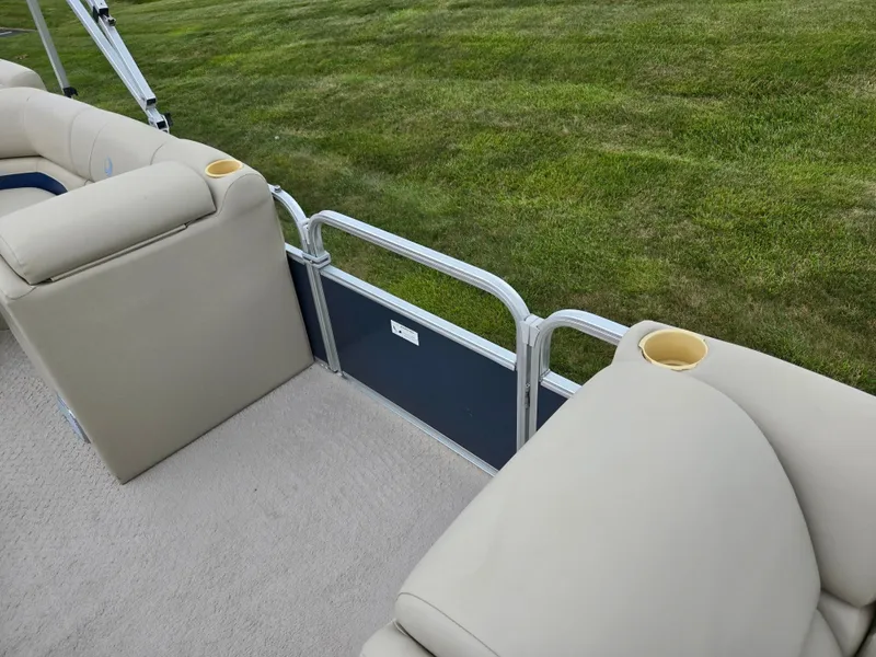 Slide: The Image of 2014 Lowe SS230 Super Sport boat interior with beige seating and cup holders. - 13