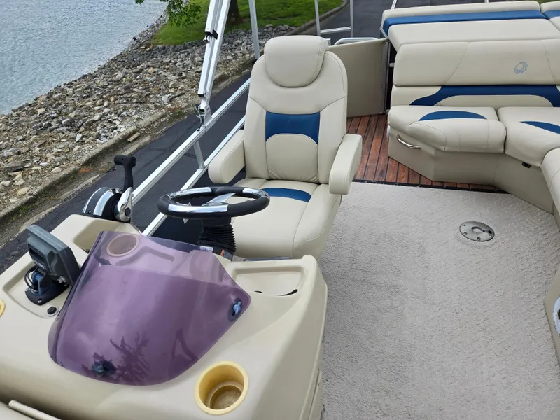 Slide: The Image of 2014 Lowe SS230 Super Sport boat interior with steering wheel and seating. - 14