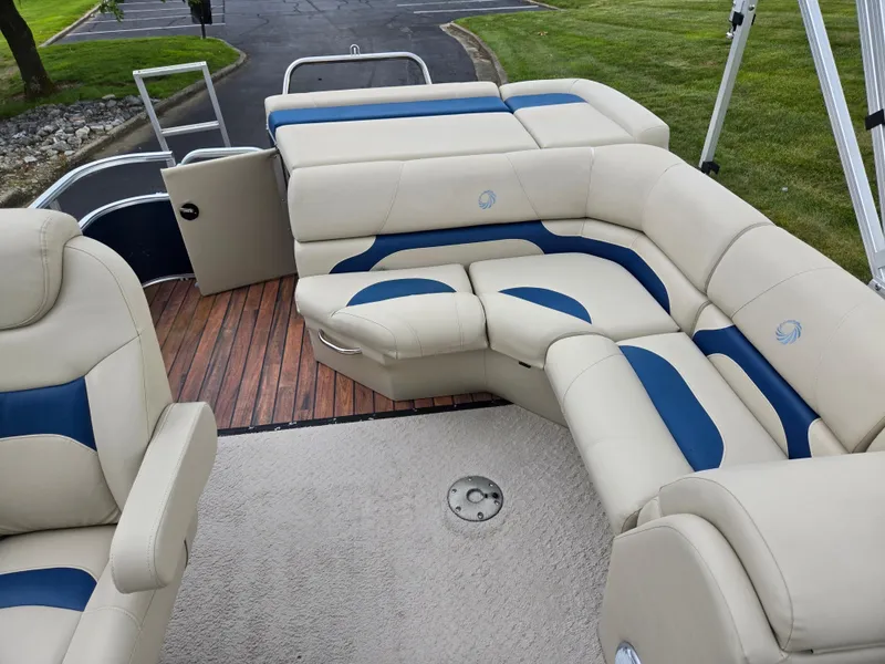 Slide: The Image of 2014 Lowe SS230 Super Sport boat with plush beige and blue seating, wooden deck. - 15