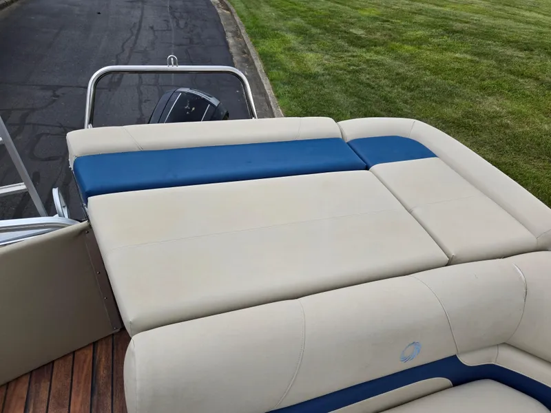 Slide: The Image of 2014 Lowe SS230 Super Sport boat with beige and blue seating, parked on pavement. - 16