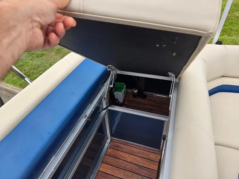 Slide: The Image of Open storage compartment on a 2014 Lowe SS230 Super Sport boat, revealing interior details. - 17