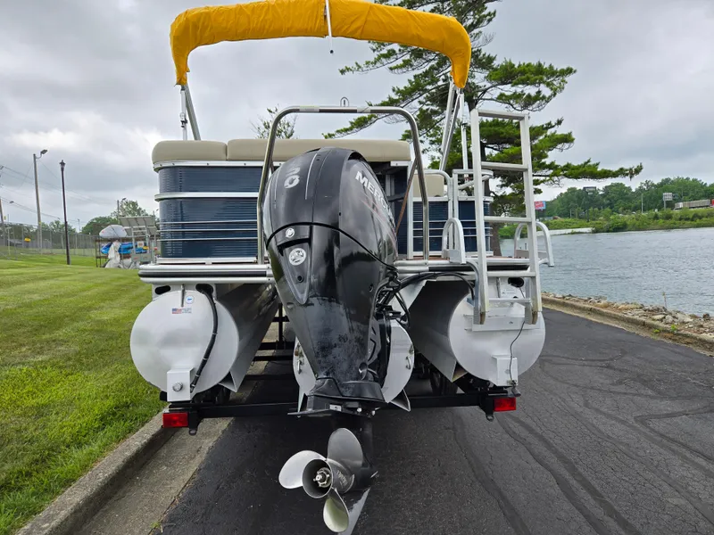 Slide: The Image of 2014 Lowe SS230 Super Sport pontoon boat with Mercury outboard motor by a lakeside. - 2