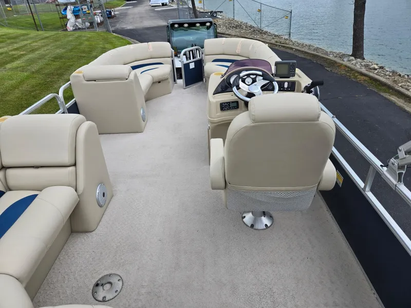 Slide: The Image of 2014 Lowe SS230 Super Sport pontoon boat interior with beige seating and steering console. - 20