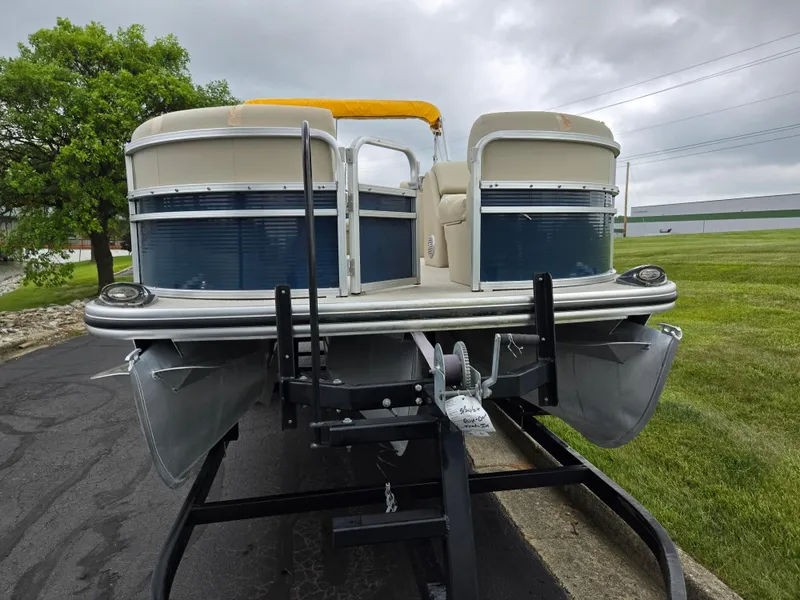 Slide: The Image of 2014 Lowe SS230 Super Sport pontoon boat on trailer, parked on paved surface. - 6