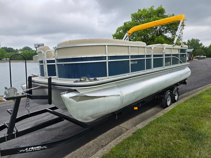 Slide: The Image of 2014 Lowe SS230 Super Sport pontoon boat on trailer by a lake. - 9