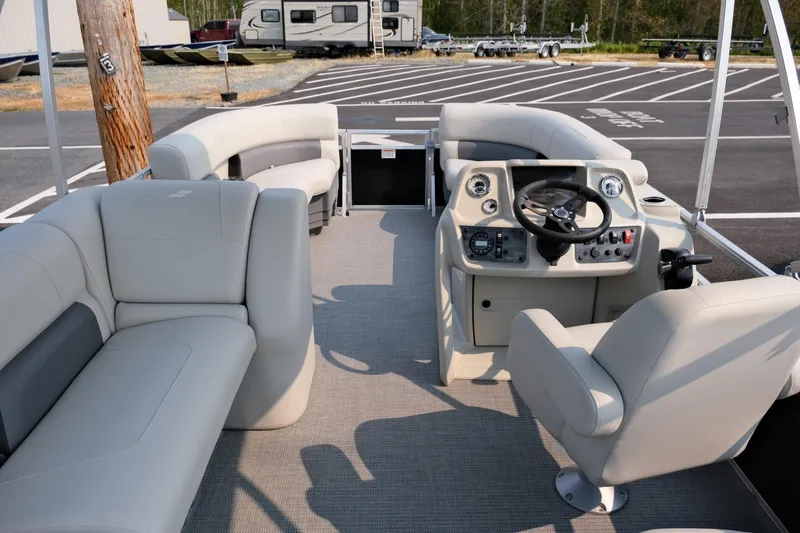Slide: The Image of 2023 Starcraft LX 18 R pontoon boat interior with modern helm and seating. - 12