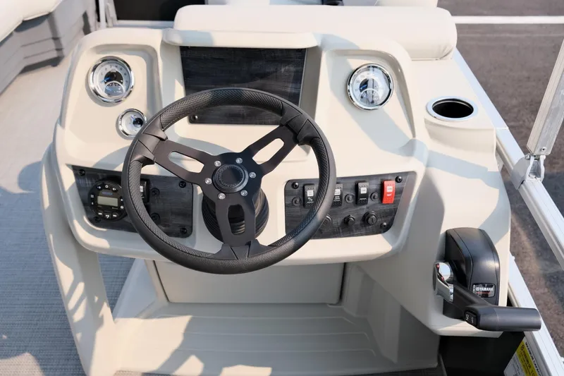Slide: The Image of 2023 Starcraft LX 18 R boat dashboard with steering wheel and controls. - 14