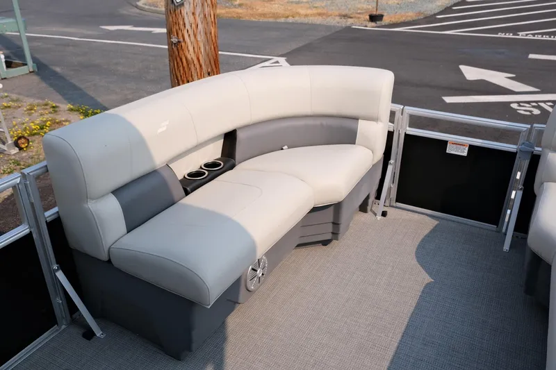 Slide: The Image of 2023 Starcraft LX 18 R boat interior with gray seating and cup holders. - 18