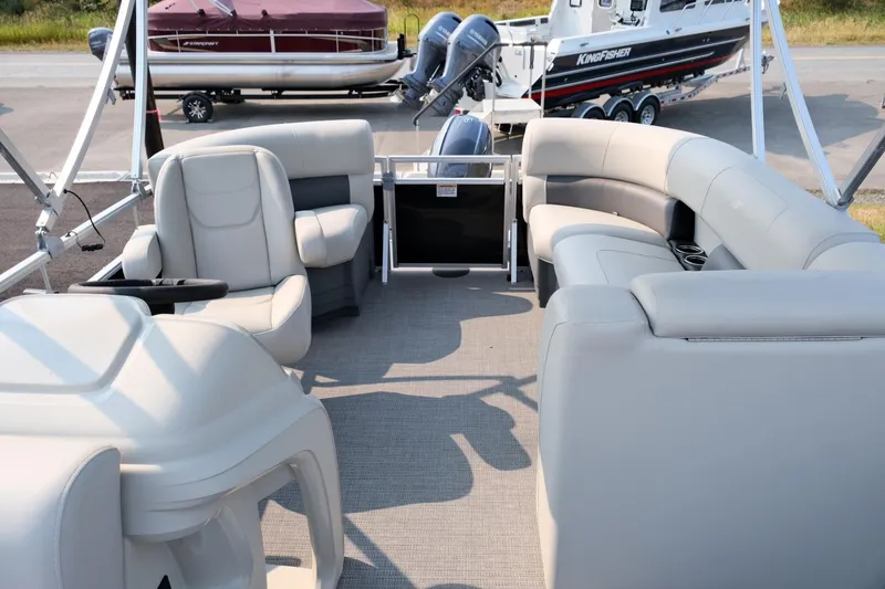 Slide: The Image of 2023 Starcraft LX 18 R pontoon boat interior with plush seating and modern design. - 9
