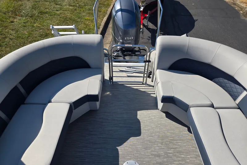 Slide: The Image of 2022 Bennington L 22 Quad Bench pontoon boat with spacious seating and outboard motor. - 17