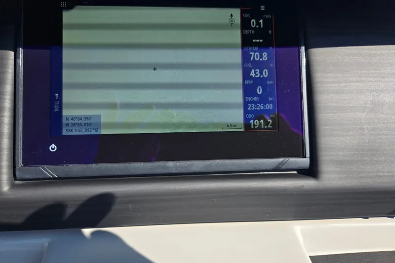 Slide: The Image of Dashboard display of a 2022 Bennington L 22 Quad Bench boat showing navigation and engine data. - 24