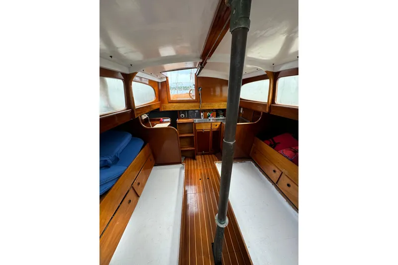 Slide: The Image of Interior of 1960 Alden Challenger 38 sailboat with wooden furnishings and cozy sleeping areas. - 17