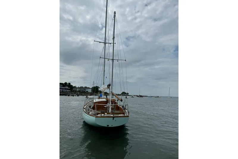 Slide: The Image of 1960 Alden Challenger 38 sailboat on calm water under cloudy sky. - 2