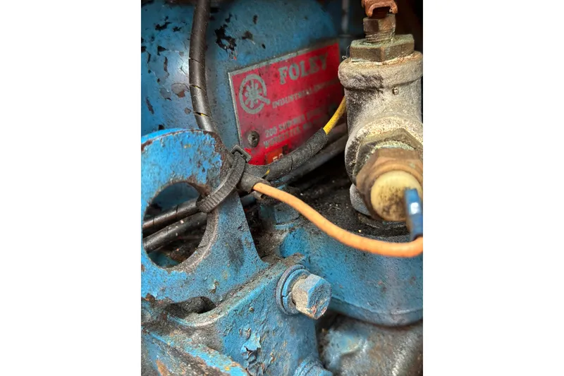 Slide: The Image of Close-up of a 1960 Alden Challenger 38 engine with visible wiring and components. - 22