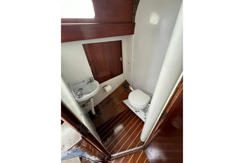 Slide: The Image of 1960 Alden Challenger 38 yacht bathroom with wooden flooring and compact fixtures. - 25